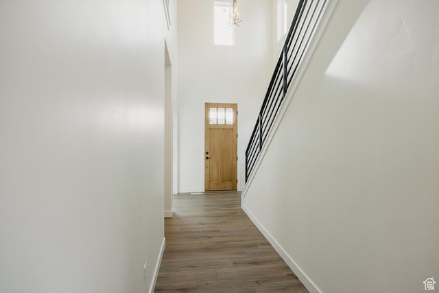 5976 N Canyon Rim Rd E Unit 615, Lehi, UT 84043 - corridor featuring stairs, dark wood-type flooring, a high ceiling, and a chandelier