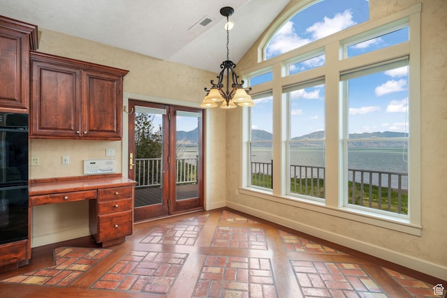 238 N Vista Ct, Saratoga Springs, UT 84045 - kitchen featuring brick flooring, vaulted ceiling, a chandelier, decorative light fixtures, and a water and mountain view