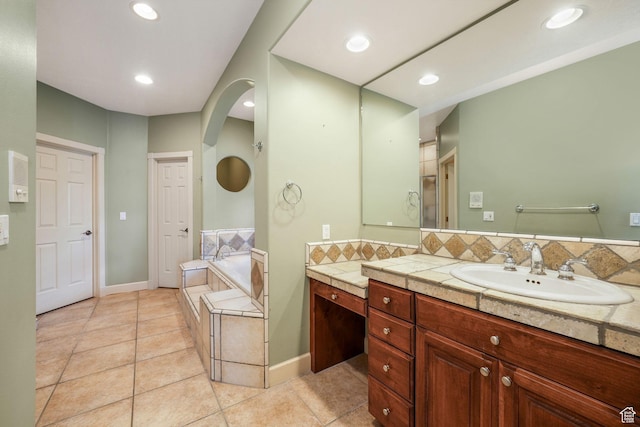 238 N Vista Ct, Saratoga Springs, UT 84045 - bathroom featuring vanity, a bath, tile patterned flooring, tasteful backsplash, and recessed lighting