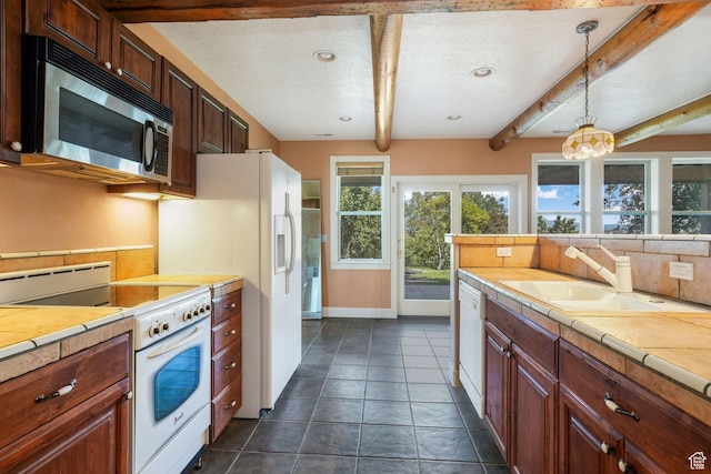 238 N Vista Ct, Saratoga Springs, UT 84045 - kitchen with white appliances, tile countertops, beamed ceiling, hanging light fixtures, and dark tile patterned floors