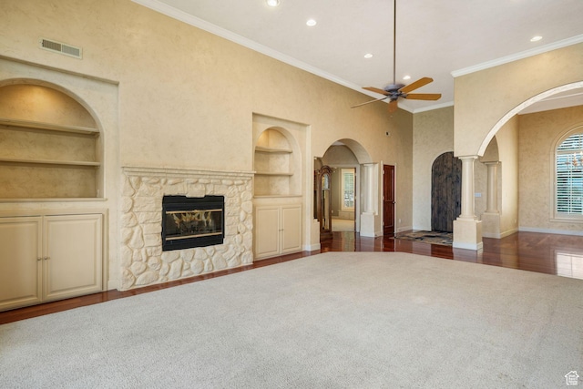 238 N Vista Ct, Saratoga Springs, UT 84045 - unfurnished living room featuring built in shelves, arched walkways, a ceiling fan, recessed lighting, and decorative columns