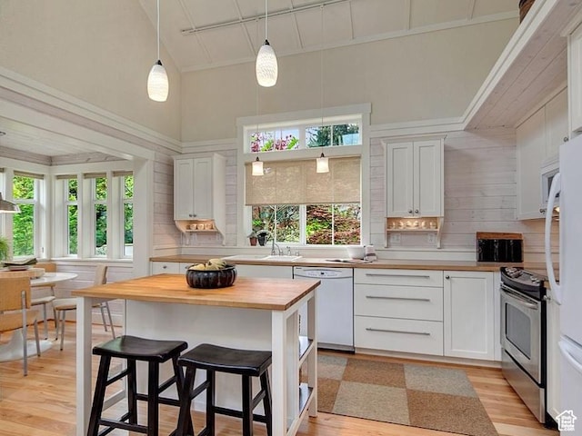 247 W 200 S, Santaquin, UT 84655 - kitchen featuring white appliances, wood counters, light wood finished floors, white cabinets, and high vaulted ceiling