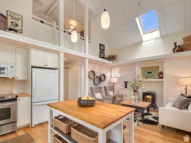 247 W 200 S, Santaquin, UT 84655 - kitchen featuring white appliances, a skylight, light wood-style floors, open floor plan, and high vaulted ceiling