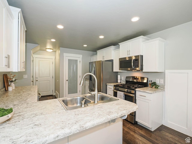 5229 W Armada Way, Herriman, UT 84096 - kitchen featuring stainless steel appliances, dark wood finished floors, white cabinets, recessed lighting, and a peninsula