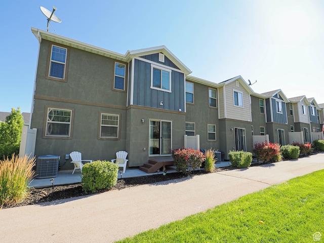 5229 W Armada Way, Herriman, UT 84096 - rear view of property with board and batten siding, a patio, and a residential view