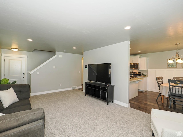 5229 W Armada Way, Herriman, UT 84096 - living room featuring a chandelier, dark carpet, and recessed lighting