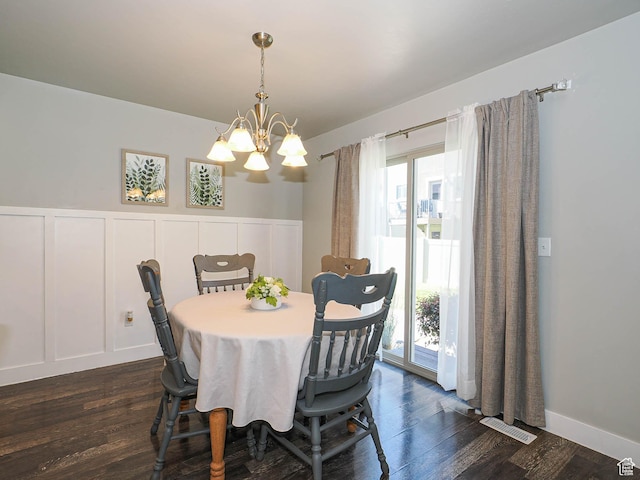 5229 W Armada Way, Herriman, UT 84096 - dining room featuring a chandelier, plenty of natural light, a decorative wall, dark wood-style flooring, and a wainscoted wall