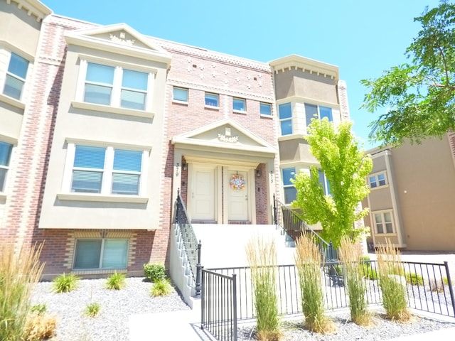 375 W Park Vw S, Spanish Fork, UT 84660 - view of front facade with stucco siding, brick siding, and a fenced front yard