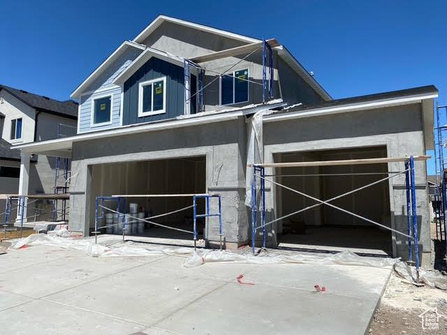 462 W Sapphire Dr Unit 7016, Tooele, UT 84074 - view of front of house with a garage, concrete driveway, and stucco siding