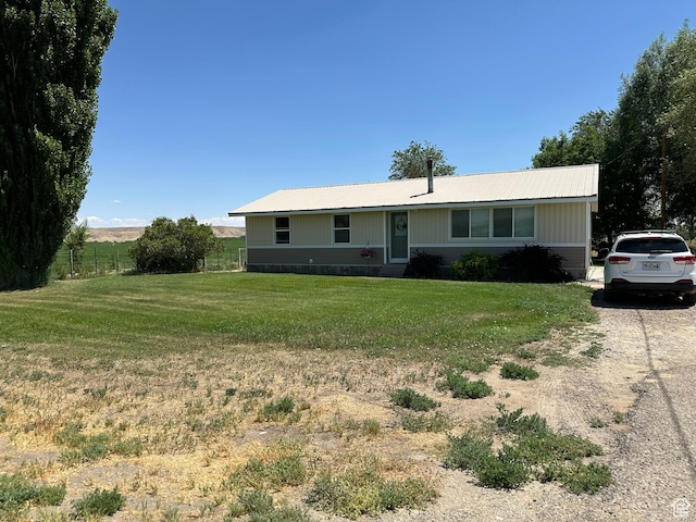 8744 E 6500 S, Jensen, UT 84035 - ranch-style home with a front lawn, a metal roof, and driveway