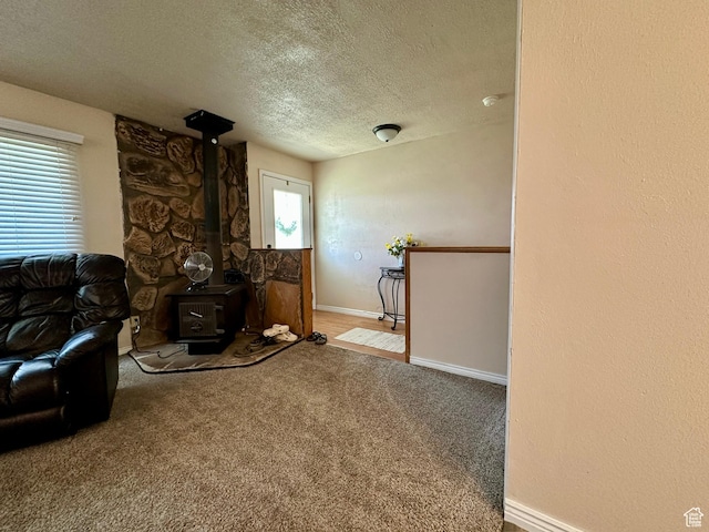 8744 E 6500 S, Jensen, UT 84035 - carpeted living room with a textured ceiling and a wood stove