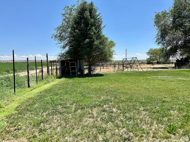 8744 E 6500 S, Jensen, UT 84035 - view of yard featuring a storage unit and a playground