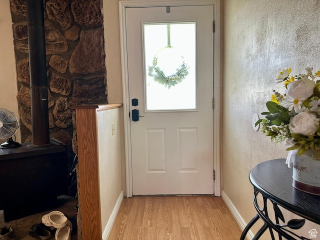 8744 E 6500 S, Jensen, UT 84035 - entryway featuring a wood stove, light wood finished floors, and plenty of natural light
