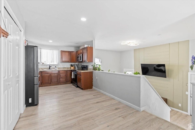 4706 W Roundtable Rd S, West Valley City, UT 84120 - kitchen featuring stainless steel appliances, light wood-style flooring, brown cabinetry, recessed lighting, and open floor plan