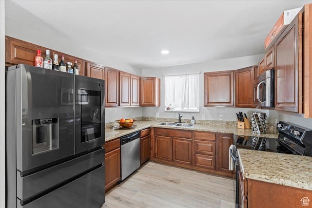 4706 W Roundtable Rd S, West Valley City, UT 84120 - kitchen with stainless steel appliances, brown cabinets, light wood finished floors, and recessed lighting