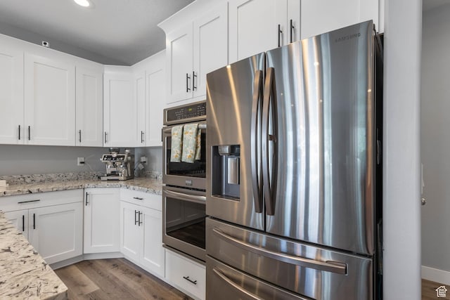 406 Zachary Way, Grantsville, UT 84029 - kitchen featuring stainless steel appliances, light wood finished floors, white cabinetry, light stone counters, and recessed lighting
