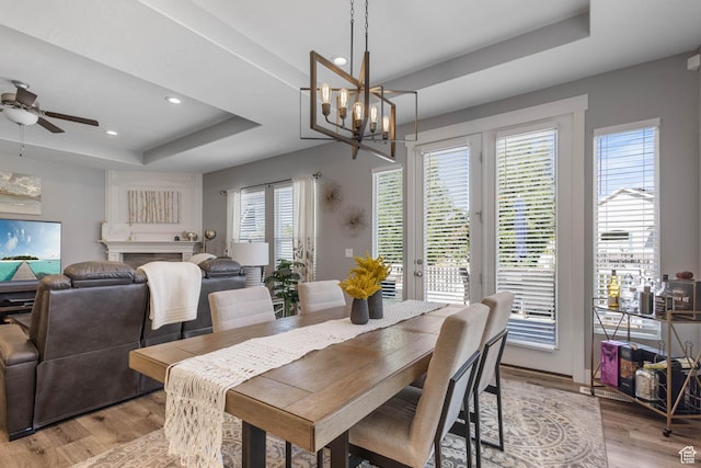 406 Zachary Way, Grantsville, UT 84029 - dining room featuring a tray ceiling, recessed lighting, light wood-style floors, a chandelier, and a ceiling fan