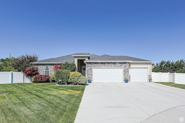 406 Zachary Way, Grantsville, UT 84029 - prairie-style home featuring a garage, stone siding, and concrete driveway