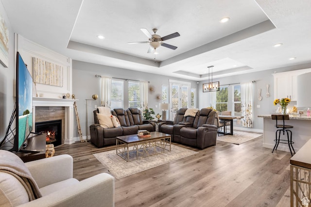 406 Zachary Way, Grantsville, UT 84029 - living room with a raised ceiling, plenty of natural light, light wood finished floors, a ceiling fan, and recessed lighting