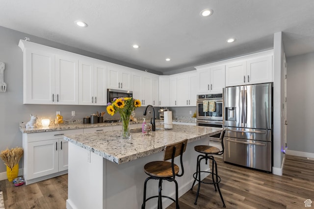406 Zachary Way, Grantsville, UT 84029 - kitchen featuring stainless steel appliances, dark wood-style floors, white cabinetry, recessed lighting, and a breakfast bar area