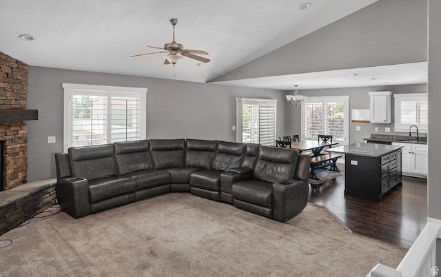 4449 W 5325 S, Hooper, UT 84315 - living area featuring a ceiling fan, vaulted ceiling, a chandelier, dark carpet, and dark wood-style flooring