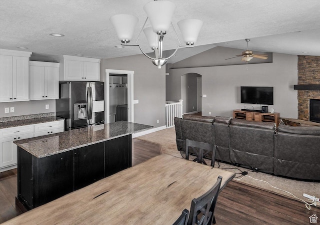 4449 W 5325 S, Hooper, UT 84315 - kitchen with fridge with ice dispenser, ceiling fan, arched walkways, a center island, and vaulted ceiling