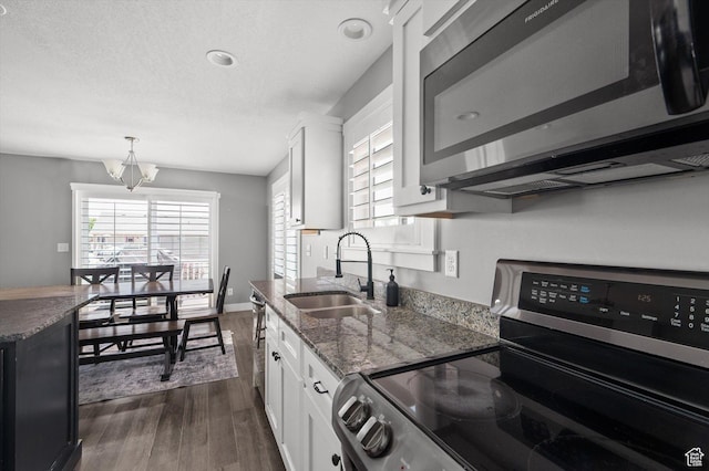 4449 W 5325 S, Hooper, UT 84315 - kitchen with electric stove, dark wood-type flooring, white cabinetry, dark stone countertops, and pendant lighting