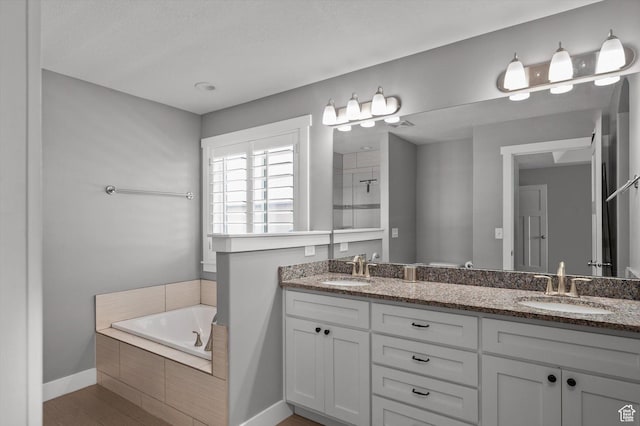 4449 W 5325 S, Hooper, UT 84315 - bathroom featuring double vanity, a garden tub, a tile shower, and wood finished floors