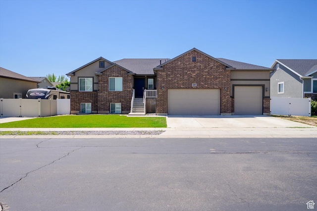 4449 W 5325 S, Hooper, UT 84315 - view of front of property featuring a garage, a gate, driveway, and brick siding