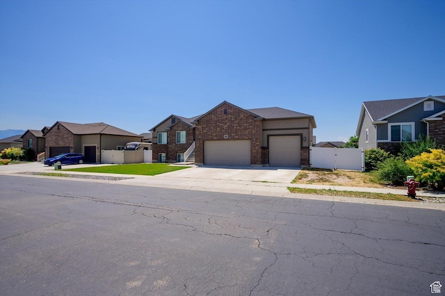 4449 W 5325 S, Hooper, UT 84315 - view of front of house with an attached garage, a gate, concrete driveway, brick siding, and a residential view