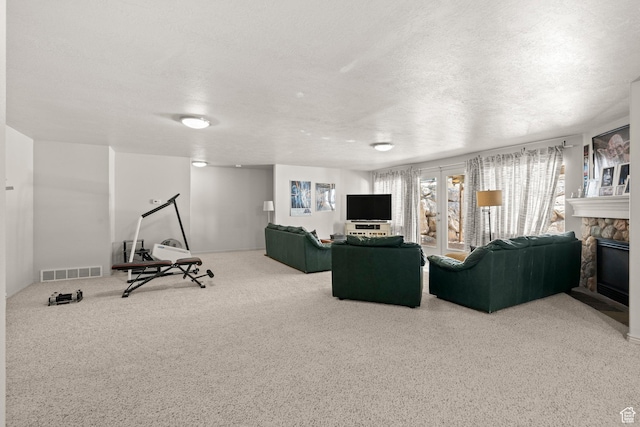 135 W Cove Dr, Elk Ridge, UT 84651 - living room with a stone fireplace, a textured ceiling, and carpet flooring