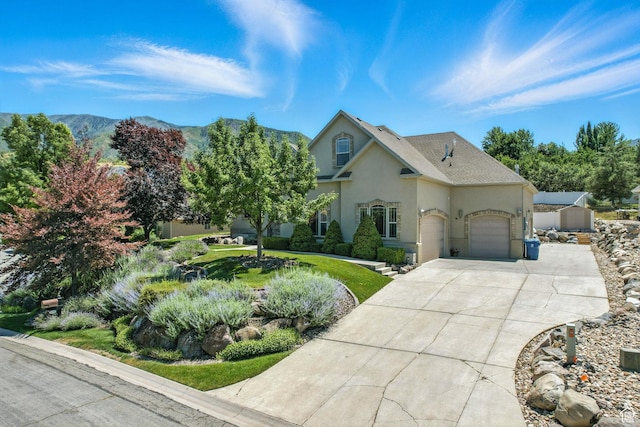 135 W Cove Dr, Elk Ridge, UT 84651 - view of front of house with stucco siding, concrete driveway, and an attached garage