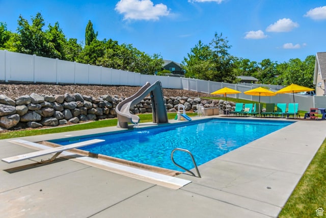 135 W Cove Dr, Elk Ridge, UT 84651 - view of pool with a water slide, a fenced backyard, a diving board, and a patio area