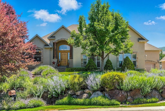 135 W Cove Dr, Elk Ridge, UT 84651 - view of front of house with stucco siding and a garage