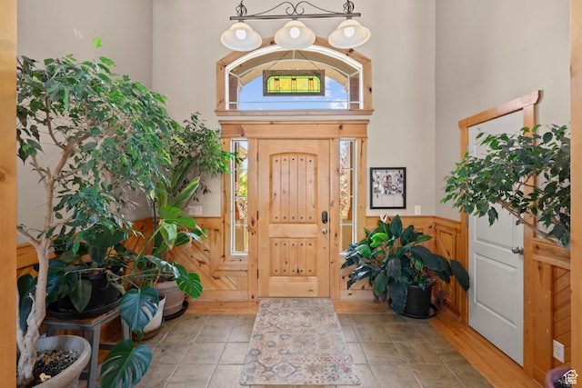 135 W Cove Dr, Elk Ridge, UT 84651 - entryway featuring wainscoting, a towering ceiling, and wood walls