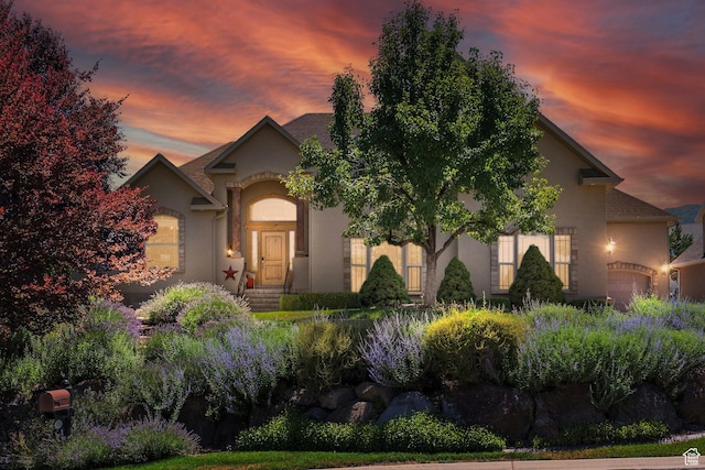 135 W Cove Dr, Elk Ridge, UT 84651 - view of front facade featuring stucco siding and a garage