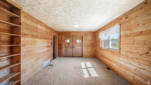 403 E Center, Nephi, UT 84648 - entrance foyer featuring wooden walls, carpet floors, and a textured ceiling