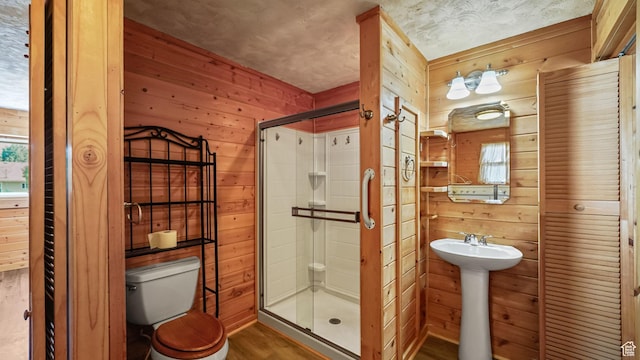 403 E Center, Nephi, UT 84648 - bathroom featuring wooden walls, wood finished floors, and a shower stall