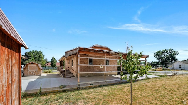 403 E Center, Nephi, UT 84648 - rear view of property with a storage unit, a yard, and a patio area