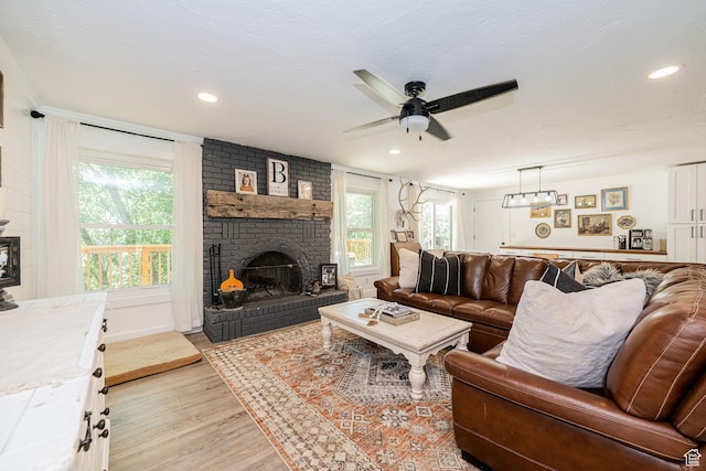 2127 E 5950 N, Liberty, UT 84310 - living room featuring a fireplace, light wood-style flooring, a ceiling fan, and recessed lighting