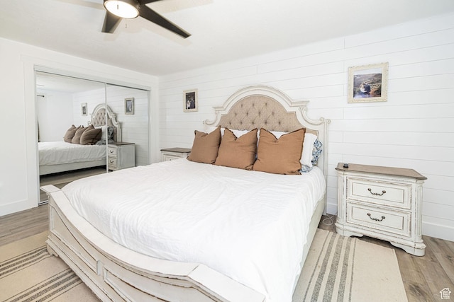 2127 E 5950 N, Liberty, UT 84310 - bedroom featuring light wood-style floors, a closet, a ceiling fan, and wooden walls
