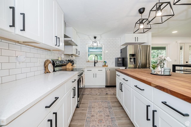 2127 E 5950 N, Liberty, UT 84310 - kitchen featuring stainless steel appliances, wooden counters, white cabinets, decorative backsplash, and decorative light fixtures
