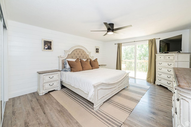 2127 E 5950 N, Liberty, UT 84310 - bedroom featuring access to outside, light wood-style floors, a ceiling fan, and wood walls