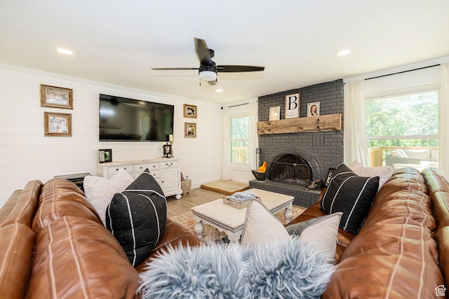 2127 E 5950 N, Liberty, UT 84310 - living room with wood finished floors, healthy amount of natural light, a ceiling fan, a brick fireplace, and wooden walls