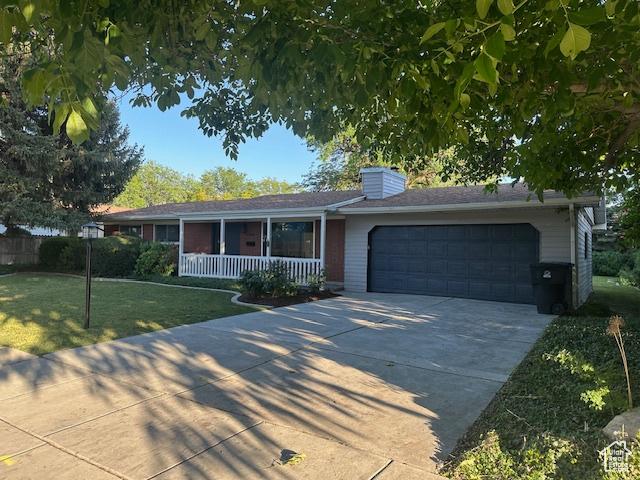 1456 E 5935 S, Murray, UT 84121 - ranch-style house with covered porch, an attached garage, a front yard, concrete driveway, and a chimney