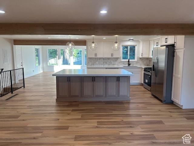 1456 E 5935 S, Murray, UT 84121 - kitchen featuring stainless steel fridge with ice dispenser, range, light wood-style floors, a kitchen island, and white cabinets