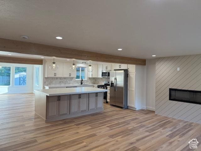 1456 E 5935 S, Murray, UT 84121 - kitchen with stainless steel appliances, light wood finished floors, recessed lighting, white cabinetry, and a large fireplace