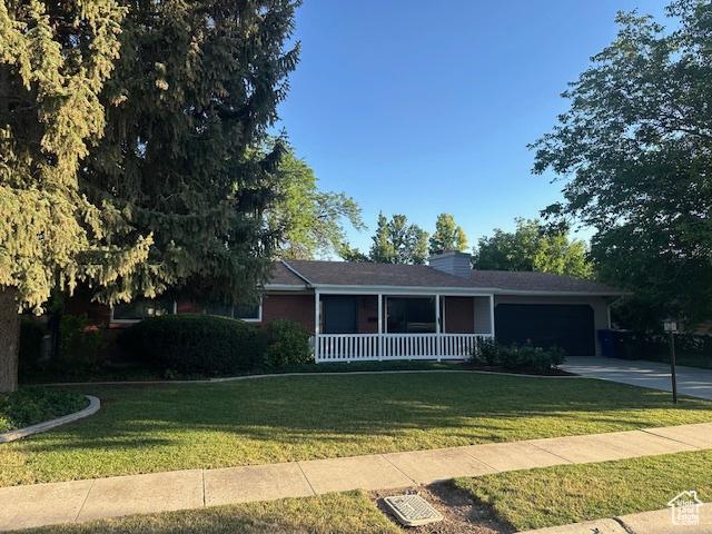 1456 E 5935 S, Murray, UT 84121 - ranch-style house featuring a garage, a porch, a front lawn, and driveway