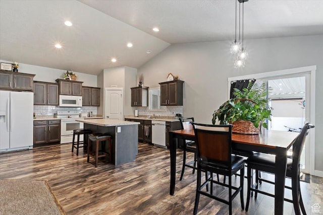 6533 W Elena St S, West Valley City, UT 84128 - dining space featuring dark wood-type flooring, lofted ceiling, and recessed lighting