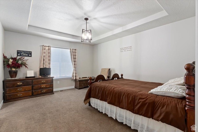 6533 W Elena St S, West Valley City, UT 84128 - bedroom featuring a tray ceiling, carpet, and a textured ceiling